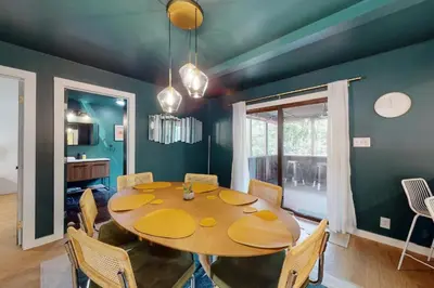 a dining room with a wooden table and chairs at Sage Grove Sanctuary 3BD Hot Tub Fire Pit in East Stroudsburg
