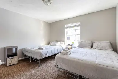 a bedroom with two beds and a tv in it at Lakeside Haven 5 BDR Fire Pit Pet Friendly in Tobyhanna