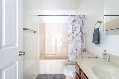 a bathroom with a toilet and a sink and a shower at Lakeside Haven 5 BDR Fire Pit Pet Friendly in Tobyhanna