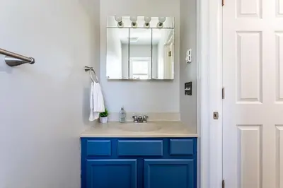 a bathroom with a blue sink and a mirror at Lakeside Haven 5 BDR Fire Pit Pet Friendly in Tobyhanna