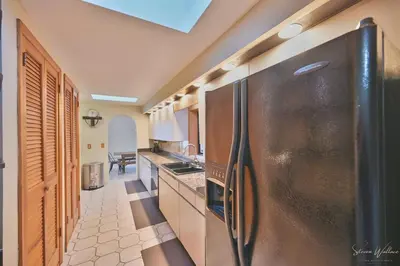 a kitchen with a large stainless steel refrigerator at Heated Indoor Private Pool Stream Front Game Room in Cresco