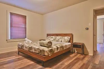 a bedroom with a large bed and a window at Heated Indoor Private Pool Stream Front Game Room in Cresco