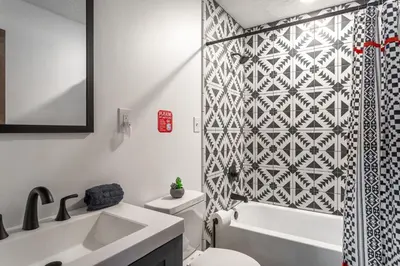 a bathroom with a toilet and a sink and a shower at Lakeside Chalet 3BR Fire Pit Pet Friendly in Tobyhanna