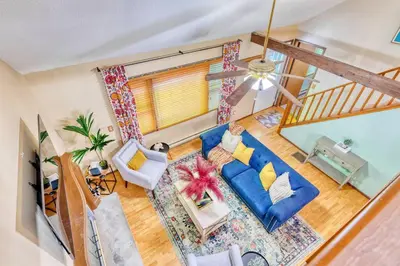 an overhead view of a living room with a blue couch at 4BDR Hot Tub Game Room in Lake Ariel
