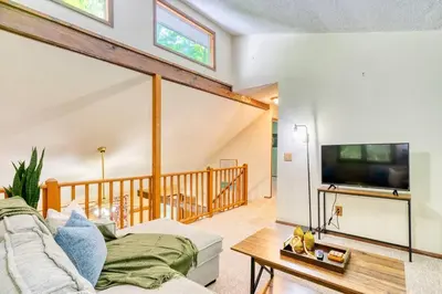 a living room with a couch and a tv at 4BDR Hot Tub Game Room in Lake Ariel
