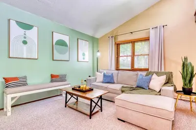 a living room with a couch and a table at 4BDR Hot Tub Game Room in Lake Ariel