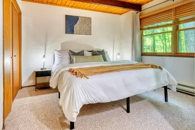 a bedroom with a bed and a window at 4BDR Hot Tub Game Room in Lake Ariel