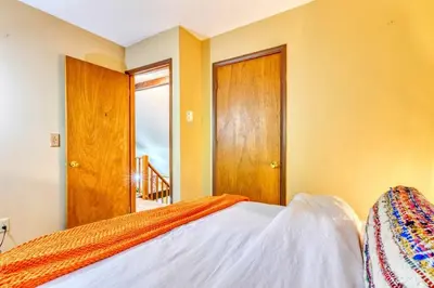 a bedroom with a bed and wooden doors at 4BDR Hot Tub Game Room in Lake Ariel