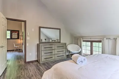 a bedroom with a bed and a dresser with a mirror at Hot Tub Secluded Fire Pit Hammock in Stroudsburg