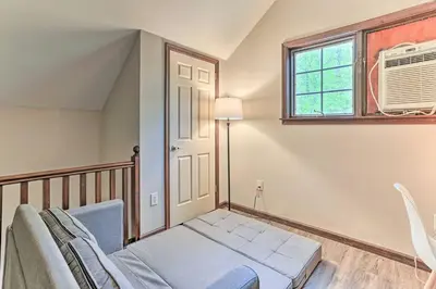 a living room with a couch and a window at Hot Tub Secluded Fire Pit Hammock in Stroudsburg
