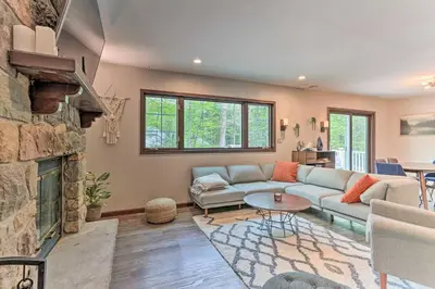 a living room with a couch and a fireplace at Hot Tub Secluded Fire Pit Hammock in Stroudsburg