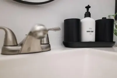 a bathroom counter with a bottle of soap and a sink at Cozy 3 BR Game Area Fire Pit in East Stroudsburg