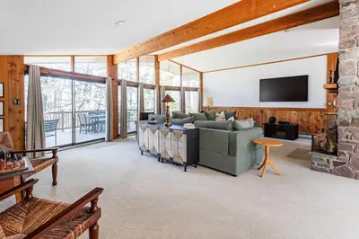a living room with a couch and a tv at Whispering Pines Chalet Game Room Fire Pit in Pocono Pines