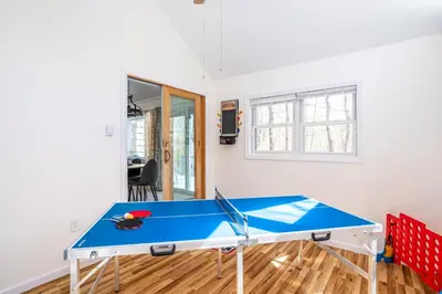 a blue ping pong table in a room at Cozy 3BD 2Minutes from Beach in East Stroudsburg