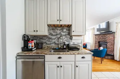 a kitchen with white cabinets and a sink at Cozy 3BD 2Minutes from Beach in East Stroudsburg