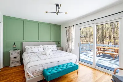 a bedroom with a bed and a large sliding glass door at Cozy 3BD 2Minutes from Beach in East Stroudsburg