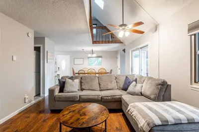 a living room with a couch and a table at Cozy 3Br Fire Pit Hammock 2 Minutes to Beach in East Stroudsburg