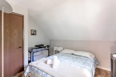 a bedroom with a bed with towels on it at Cozy 3Br Fire Pit Hammock 2 Minutes to Beach in East Stroudsburg