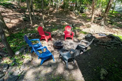 a group of chairs sitting around a fire pit at Cozy 3Br Fire Pit Hammock 2 Minutes to Beach in East Stroudsburg