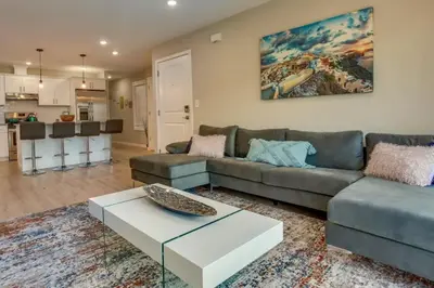 a living room with a couch and a coffee table at Spacious 6 Bedroom Home with NYC Access & Parking! in Newark