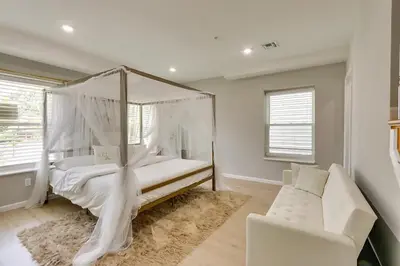 a bedroom with a white canopy bed and a couch at Spacious 6 Bedroom Home with NYC Access & Parking! in Newark