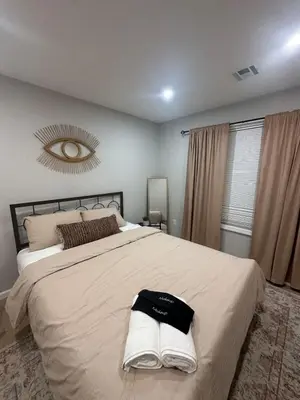 a bedroom with a large bed and a mirror at Spacious 6 Bedroom Home with NYC Access & Parking! in Newark