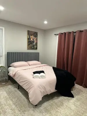 a bedroom with a bed with two glasses on it at Spacious 6 Bedroom Home with NYC Access & Parking! in Newark