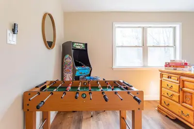 a game room with a table with baseball bats at The Buckhorn Chalet Hot Tub Arcades 6 Bedroom Fire Place in Albrightsville