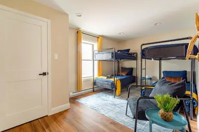 a room with three bunk beds and a table at The Buckhorn Chalet Hot Tub Arcades 6 Bedroom Fire Place in Albrightsville