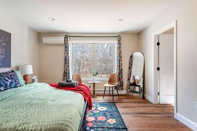 a bedroom with a bed and a window and a table at The Buckhorn Chalet Hot Tub Arcades 6 Bedroom Fire Place in Albrightsville