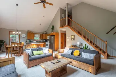 a living room with two couches and a staircase at Game Area Open Concept 4 BDR in Albrightsville