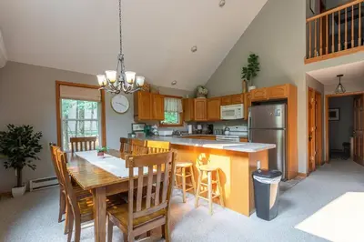 a kitchen with a wooden table and a dining room at Game Area Open Concept 4 BDR in Albrightsville