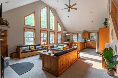 a living room with two couches and a kitchen at Game Area Open Concept 4 BDR in Albrightsville