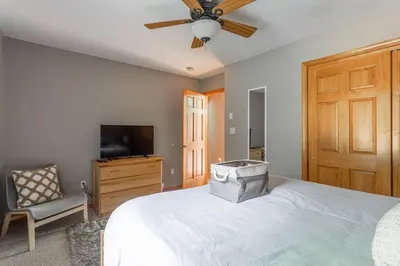 a bedroom with a bed with a ceiling fan and a television at Game Area Open Concept 4 BDR in Albrightsville
