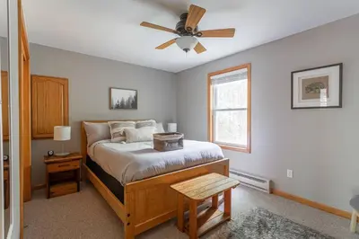 a bedroom with a bed with a ceiling fan at Game Area Open Concept 4 BDR in Albrightsville