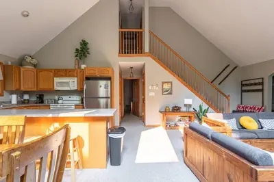 an open kitchen and living room with a staircase at Game Area Open Concept 4 BDR in Albrightsville