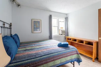 a bedroom with a bed and a window at Tranquil Shores Waterfront Fire Pit Hammock in Tobyhanna