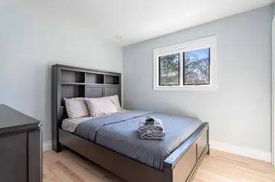 a bedroom with a bed and a window at The Woodland Escape Pool Table Fire Pit 4 BD in Tobyhanna