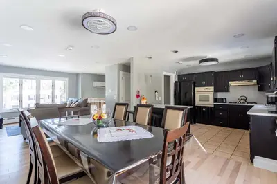 a kitchen and living room with a table and chairs at The Woodland Escape Pool Table Fire Pit 4 BD in Tobyhanna