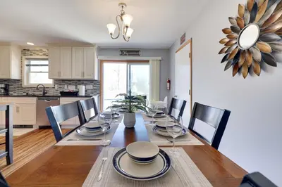 a dining room with a table and chairs and a kitchen at Cedar Cove Retreat Pool BBQ Game Room in Albrightsville