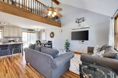a living room with two couches and a kitchen at Cedar Cove Retreat Pool BBQ Game Room in Albrightsville