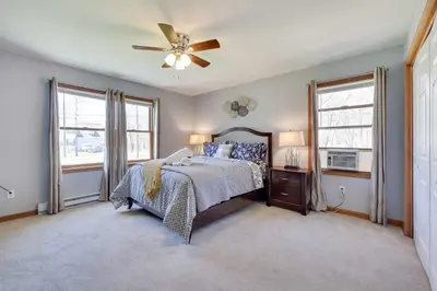 a bedroom with a bed and a ceiling fan at Cedar Cove Retreat Pool BBQ Game Room in Albrightsville