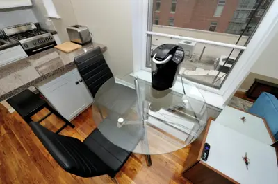 a glass table and chairs in a room at Charming 1BR in Murray Hill Kips Bay - Perfect for 2 in New York