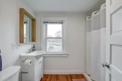 a white bathroom with a sink and a window at Walkable Dtwn Townhome Near Campus and Palmer Square in Princeton