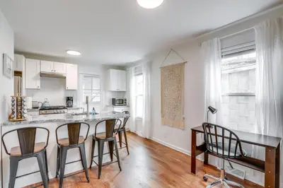 a kitchen with white cabinets and a table and chairs at Walkable Dtwn Townhome Near Campus and Palmer Square in Princeton