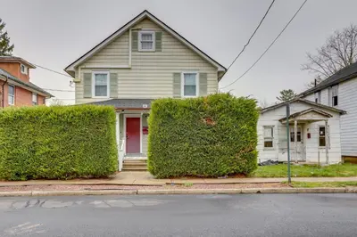 a house with two bushes in front of a street at Walkable Dtwn Townhome Near Campus and Palmer Square in Princeton