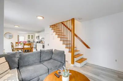 a living room with a gray couch and a wooden table at Walk to Campus and Palmer Square Dtwn Townhome in Princeton