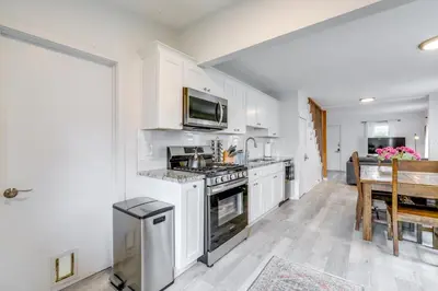 a kitchen with white cabinets and a stove top oven at Walk to Campus and Palmer Square Dtwn Townhome in Princeton