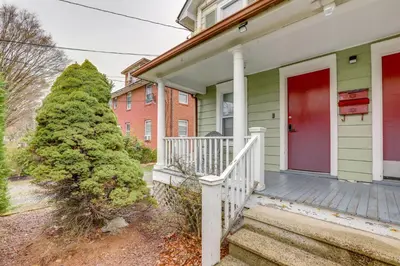 a house with a red door and a christmas tree at Walk to Campus and Palmer Square Dtwn Townhome in Princeton