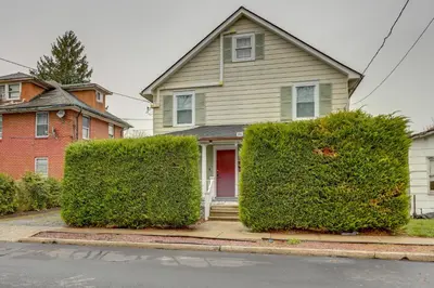 a house with two large hedges in front of it at Walk to Campus and Palmer Square Dtwn Townhome in Princeton